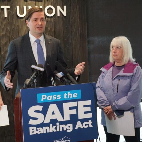 Treasurer Mike Pellicciotti speaking at podium with Senator Patty Murray